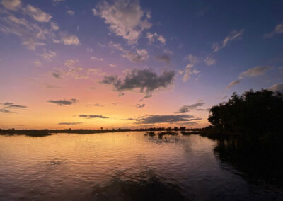 Picturesque lagoon and channel of the Okavango Delta at sunset